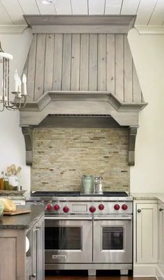 a stove top oven sitting inside of a kitchen