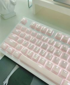 a pink keyboard sitting on top of a desk