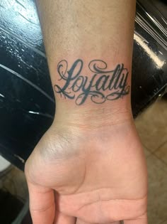 a person's hand with a tattoo that says loydallu on it