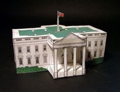 an origami model of the white house with a flag on it's roof