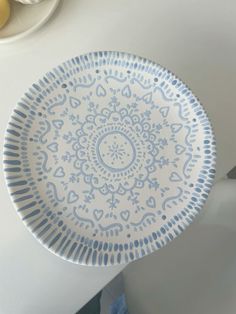 a blue and white plate sitting on top of a table