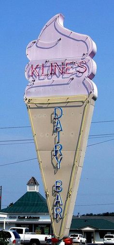 a large neon sign on the side of a building that says kline's dairy