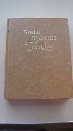 a brown book with the words bible stories that live on it sitting on a table