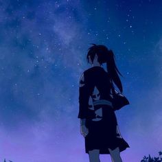 a person standing in front of a night sky