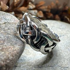 a silver ring sitting on top of a rock