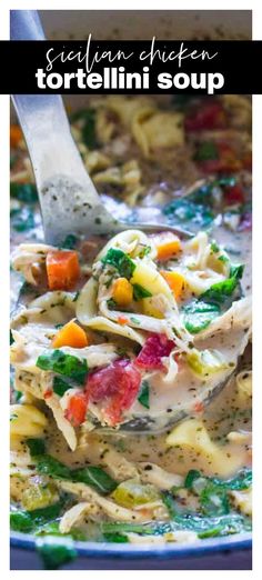 a spoon full of tortellini soup with noodles and vegetables in it, on top of a blue plate