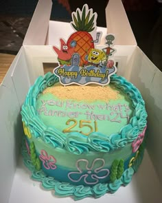 a birthday cake in a box with the number twenty five on it and an image of a pineapple