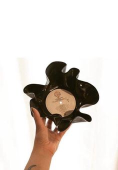 a person holding up a record in their hand