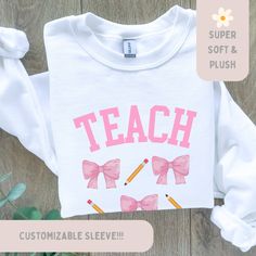 Custom Teacher Coquette Sweatshirt, Balletcore Pink Bow Sweater, Graduation Shirt, Writing Professor Crewneck, Teacher Appreciation Gift Personalizable teacher name on sleeve Or leave it blank This high-quality heavy blend crewneck sweatshirt is pure comfort and warmth. Made from polyester and cotton. No itchy side seams! Please reference all the photos for details and sizing :) ALL SALES ARE FINAL. Please read our return policy. Long Sleeve School Shirt With Graphic Print, Long Sleeve Graphic Print School Shirt, Relaxed Fit Long Sleeve School Top, White Fitted Cotton Sweatshirt, Fitted Long Sleeve Shirt With Custom Print, Long Sleeve Screen Print School T-shirt, Long Sleeve School T-shirt With Screen Print, Long Sleeve Screen Print T-shirt For School, Pink Long Sleeve T-shirt For School