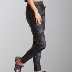 Indulge in the luxury of the Raffaello Rossi Candy Vegan Leather Jersey Pant. This sophisticated jogger-style pant features a 2" waistband and double hem look. Its decorative drawstring and front zip pockets are accented with silver hardware, adding a touch of elegance. Made with vegan leather, these pants offer the look of leather while providing comfort for any occasion. Elevate your style with this sporty and chic pant. Style Pant, Chic Pants, Jersey Pants, Fashion Joggers, Jack Black, Dress Jewelry, Unique Outfits, Sport Coat, Silver Hardware