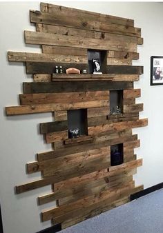 a wall made out of wooden planks with shelves on each side and pictures hanging on the wall