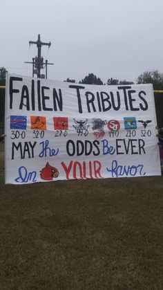 a sign that says fallen tributes may the odds be ever on your favorite team