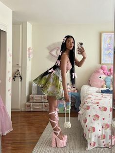 a woman taking a selfie in her bedroom with pink shoes and high heeled sandals