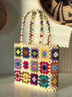 a colorful beaded purse sitting on top of a table