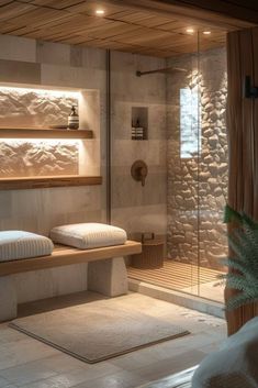 a bathroom with two beds and a glass shower stall in the corner is lit by recessed lights