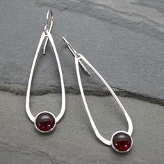 Teardrop Moonstone Earrings 8mm wine red garnets are set in sterling silver on handmade sterling silver teardrops. The teardrops swing from solid sterling silver ear wires. These earrings are 2 1/4 inches long including the ear wires. 5/8 inches at the widest part of the teardrop. For more earrings: https://www.etsy.com/shop/KiraFerrer?section_id=7937255&ref=shopsection_leftnav_3 Visit my shop at KiraFerrer.etsy.com https://www.etsy.com/shop/KiraFerrer?ref=hdr_shop_menu&page=6#items Red Sterling Silver Earrings For Everyday, Classic Sterling Silver Teardrop Earrings With Polished Finish, Classic Teardrop Earrings In Sterling Silver With Polished Finish, Classic Oval Teardrop Earrings As Gift, Classic Oval Teardrop Earrings For Gift, Oval Gemstone Teardrop Earrings As Gift, Classic Nickel-free Teardrop Earrings As Gift, Elegant Garnet Teardrop Earrings, Classic Round Garnet Earrings