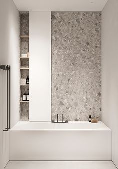 a white bath tub sitting next to a book shelf