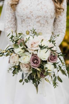 a bridal holding a bouquet of white and pink flowers