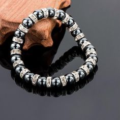 For a sparkling, yet understated addition to your collection, discover this strikingly beautiful Tibetan Silver Black Beaded Bracelet. Taking inspiration from the classic beaded bracelet, this piece features highly polished black stones spaced with Austrian Crystal bars. Providing an exceptional contrast and a stunning piece for a special occasion, this bracelet stretches to accommodate most wrist sizes and has a comfortable finish making it ideal for all day wear. Makes for a Great Gift idea! Bracelet length: 19cm Black bead size: 0.7cm Silver Stretch Bracelet With Black Beads, Elegant Hematite Beaded Bracelets With Magnetic Clasp, Elegant Adjustable Hematite Crystal Bracelet, Elegant Black Magnetic Bracelets, Silver Bracelets With Black Round Beads, Elegant Black Hematite Crystal Bracelet, Elegant Black Magnetic Beaded Bracelets, Silver Bracelet With Round Black Beads, Elegant Silver Hematite Stretch Bracelet