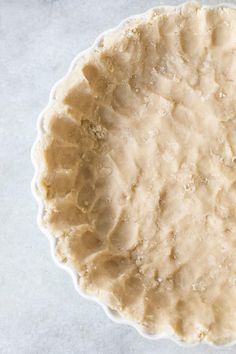 an uncooked pie crust sitting on top of a table