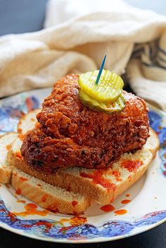 a sandwich with pickles on it sitting on a plate