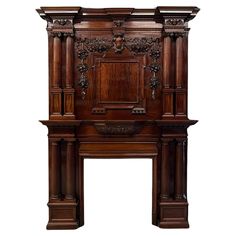 an ornate wooden fireplace surround with carvings on the top and sides, in dark wood