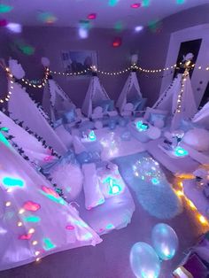 a room filled with lots of white and green lights on the walls, decorated in snowmen