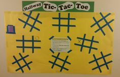 a bulletin board that has been decorated with blue and yellow strips on it, along with the words tic tac toe