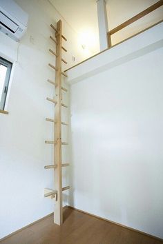 an empty room with a ladder in the corner