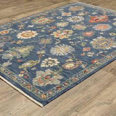 a blue rug on the floor with wooden floors