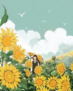 a woman standing in the middle of a field of sunflowers