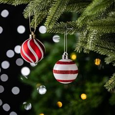 red and white ornaments hanging from a christmas tree