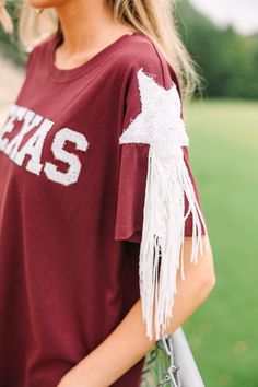 Well, howdy! If you are a Texas A&M we have the top for you! It's the perfect combination of comfy, spirited, and a definitely extra! We love the sequin varsity lettering but those sequin stars on the arms with that fringe!!! Girl! It's everything! Round neckline Short sleeves with sequin star appliques and fringe Sequin varsity lettering Fair stretch London is wearing the small. Fall Cotton Tops With Sequins, Casual Red Sequined Tops, Red Sequin Top, Varsity Letter, Mint Julep Boutique, Maroon Red, Red Sequin, Mint Julep, Model Fits