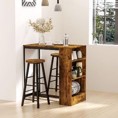 two stools sit at the end of a table in a room with white walls and wooden floors