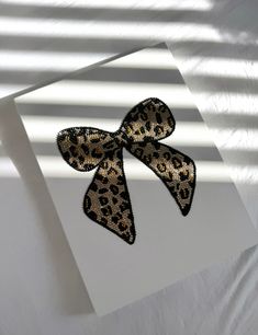 an animal print bow on top of a card