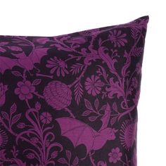 a purple and black pillow with flowers on it