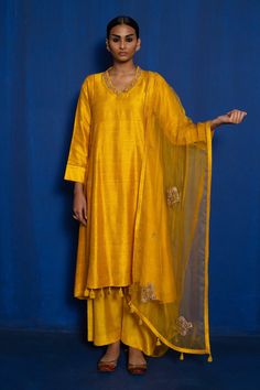 Yellow raw silk straight kurta with hand embroidery of zardozi. Comes with pant and semi sheer dupatta.
Component: 3
Pattern: Hand Embroidered
Type Of Work: Zardozi
Neckline: V-Neck
Sleeve Type: Three Quarter
Fabric: Raw Silk, Organza
Color: Yellow
Other Details: 
Floral buttis on kurta and dupatta
Tassel hem details
Back button closure on kurta
Occasion: Mehendi and Haldi - Aza Fashions Unstitched Palazzo Set With Zari Work In Raw Silk, Designer Raw Silk Palazzo Set With Resham Embroidery, Designer Slub Silk Palazzo Set With Straight Kurta, Diwali Raw Silk Palazzo Set With Resham Embroidery, Embroidered Slub Silk Palazzo Set, Festive Tissue Silk Palazzo Set With Dabka Work, Straight Kurta In Tissue Silk With Dabka Work, Festive Unstitched Raw Silk Palazzo Set, Straight Kurta Anarkali Set With Resham Embroidery