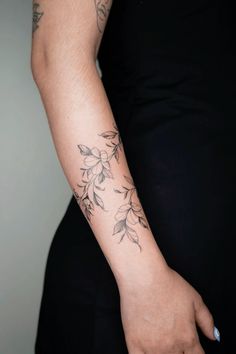 a woman with a flower tattoo on her arm