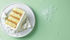 a piece of cake sitting on top of a white plate next to a green wall