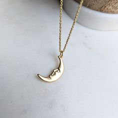 Man in the Moon Face Necklace 🌛 The detailed pendant is made of brass and then plated in high quality matte gold. The chain is stainless steel, which means it is hypoallergenic, tarnish resistant, and rust proof 😊 Just choose the length you would like before checkout 🌒 This comes in either silver or gold, just choose in the options box 💛 I have so many celestial items in my shop, this looks so good layered with my other items! I pair it with my gold labradorite choker ✨ Hope you're finding s Moon Shaped Brass Necklace With Moon Charm, Brass Moon-shaped Necklace With Moon Charm, Crescent Moon Phase Brass Necklace, Brass Crescent Moon Phase Necklace, Brass Moon Charm Jewelry, Gold Moon Charm Necklaces, Gold Moon Phase Charm Necklace, Gold Charm Necklace With Moon Phase, Gold Half Moon Charm Necklace