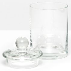 a glass container with a lid and a small glass bowl