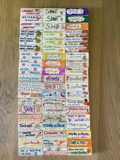 a bunch of stickers that are on top of a wooden floor with words written in them