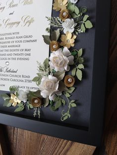 a wedding card with paper flowers on it