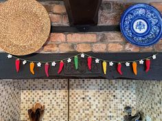 decorative items are hanging on the brick wall above a stove top in a kitchen with tiled backsplash