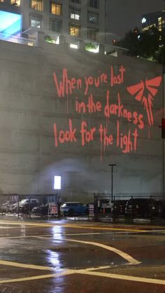 an advertisement on the side of a building that says when you're lost in the darkness i look for the light