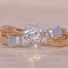 two gold and silver rings with hearts on them