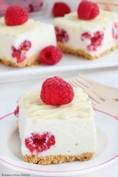 a piece of cheesecake with raspberry topping on a plate next to a fork