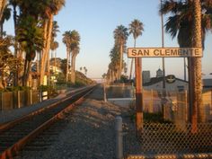 a train track with palm trees and a sign that says san clement