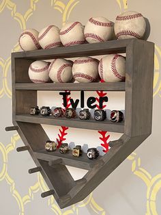 a wooden shelf filled with baseballs on top of a wall