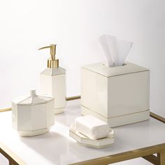 a bathroom set consisting of soap dispenser, tissue box and napkin holder